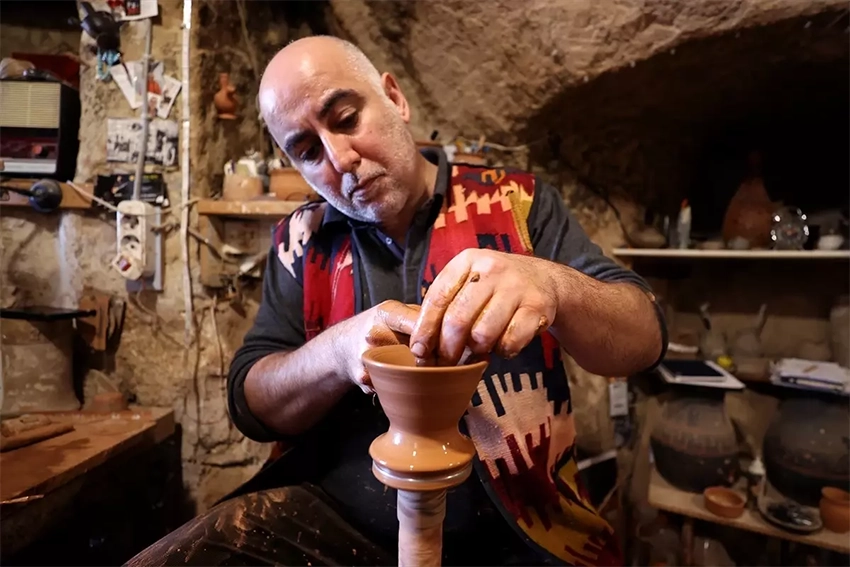 Avanos pottery master shaping clay on foot-powered wheel