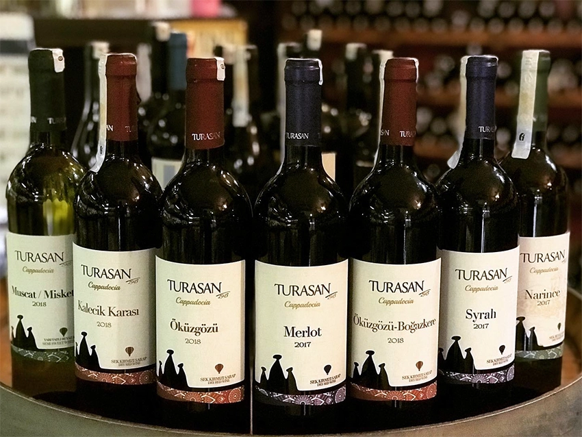 Wine tasting setup in Cappadocia with glasses, cheese, and local pottery