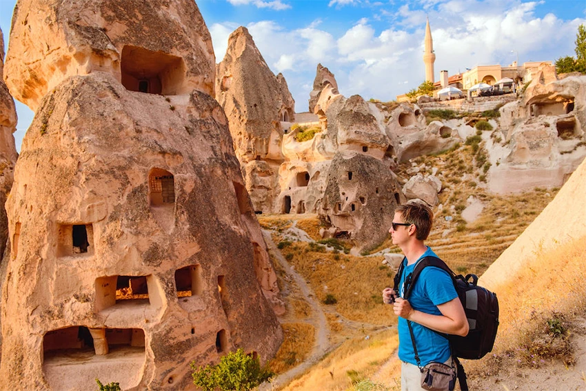 Tourist walking through Göreme streets with camera