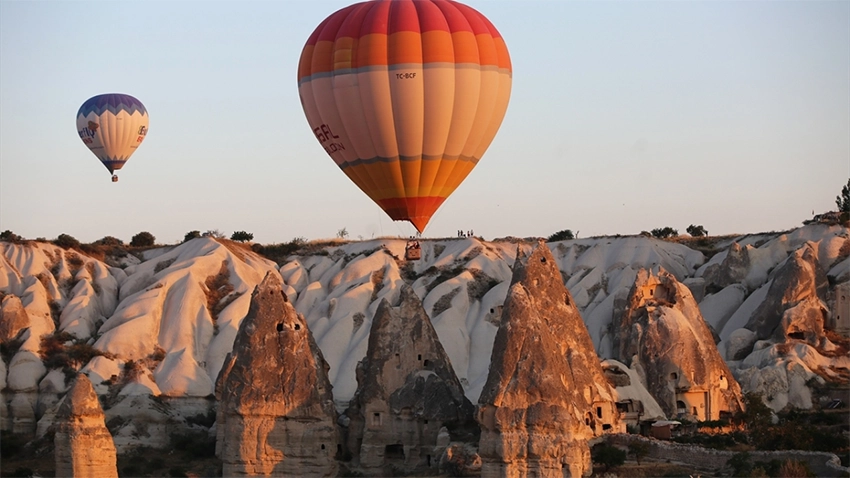 Hot air balloons rising over Göreme from Sunset Point
