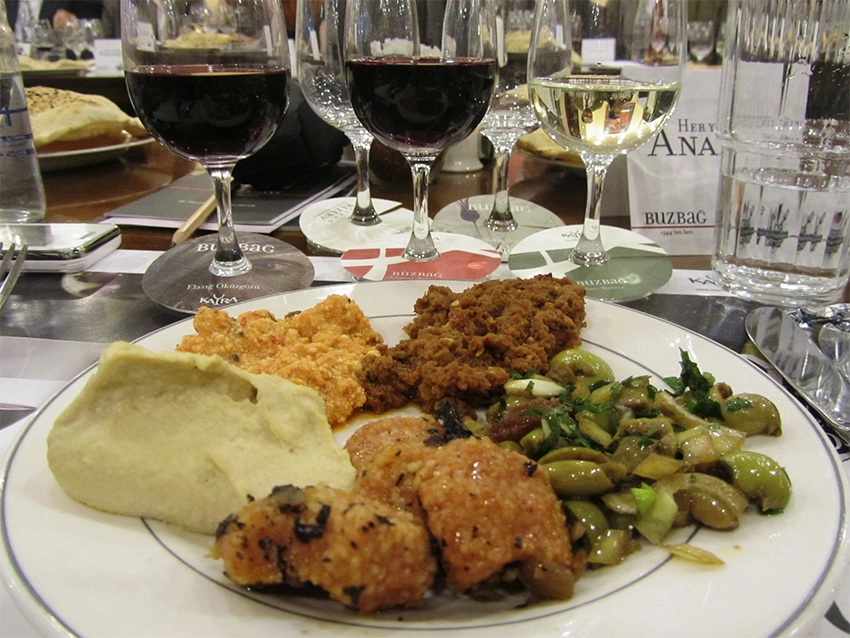 Bottle and glass of Kalecik Karası red wine with Anatolian dishes