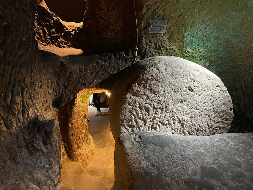 Defense holes above stone doors in Özkonak Underground City