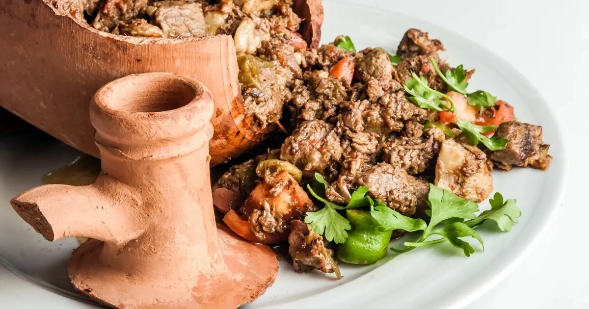 Testi Kebab being cracked open at table in Cappadocia restaurant