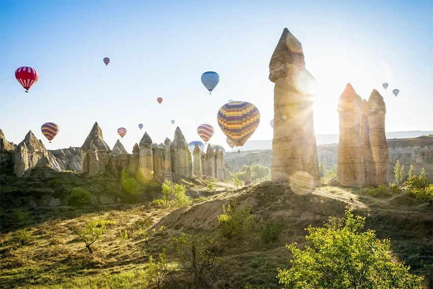 Panoramic view of Cappadocia with balloons, valleys and fairy chimneys